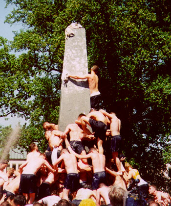 Naval Acedemy Plebes (freshman class) climb the greased 21 foot Herndon Naval Acedemy Plebes (freshman class) climb the greased 21 foot Herndon